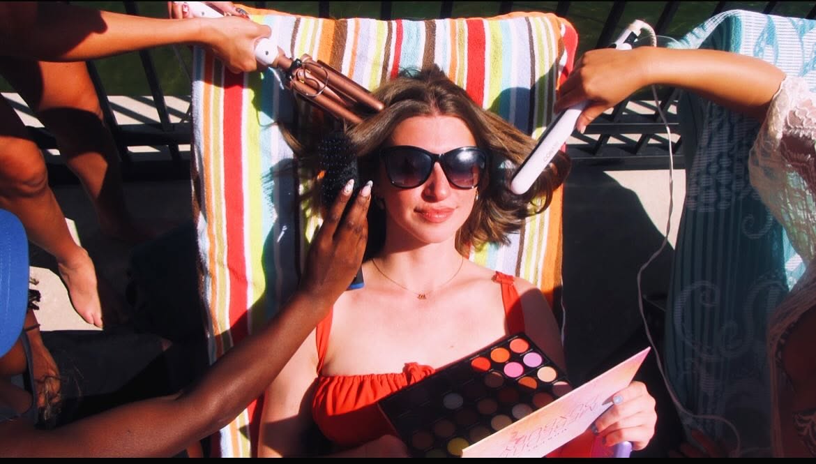 Behind-the-scenes hair and makeup styling poolside